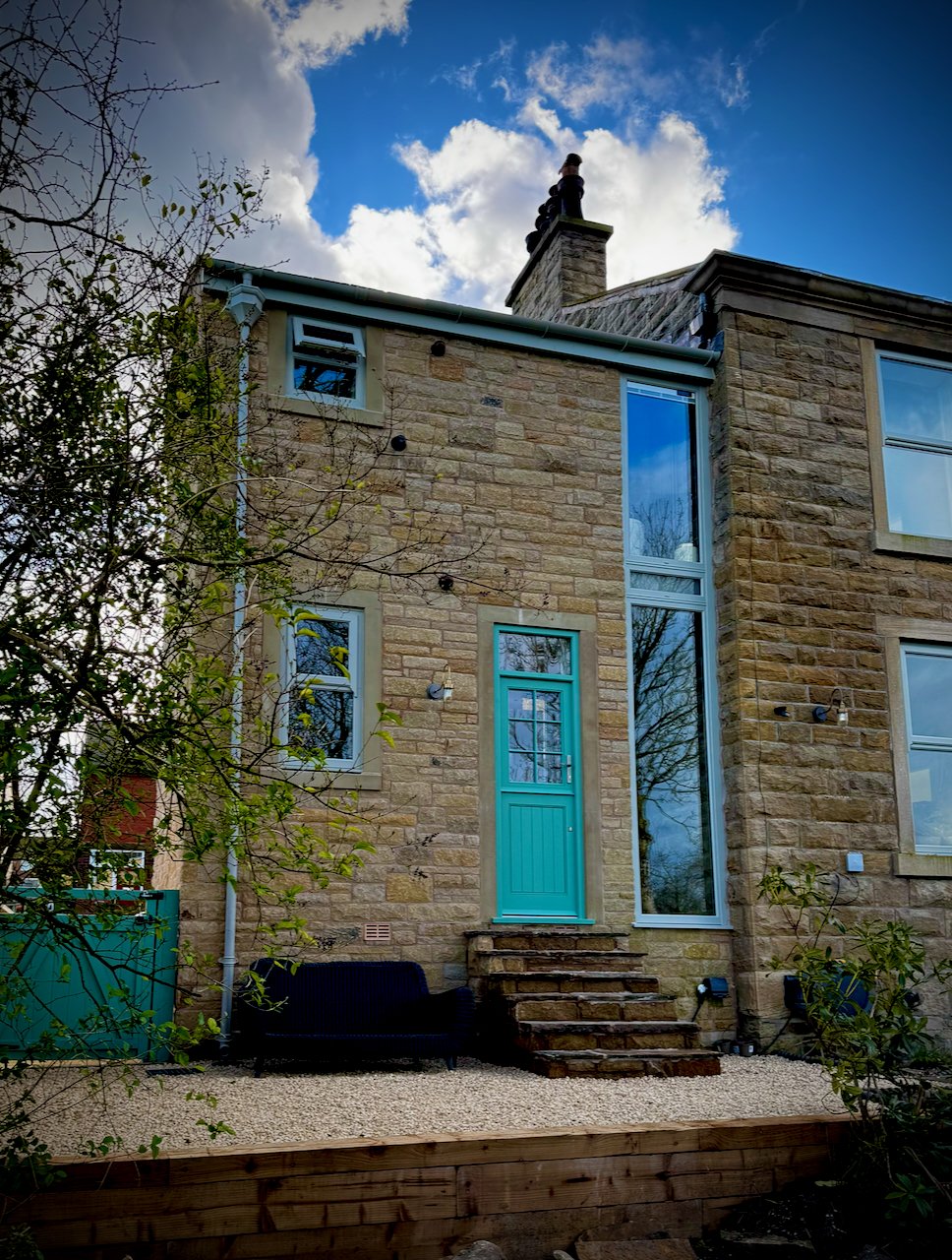 The finished two-storey extension with the new turquoise door (4/5)