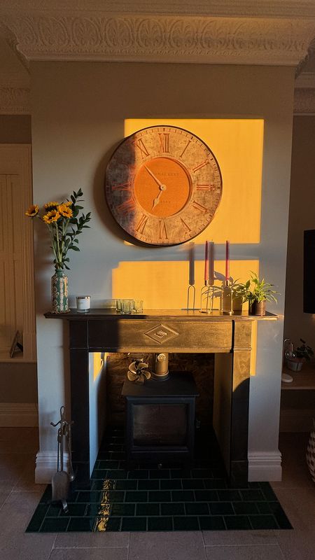 Fireplace with clock and sunflowers